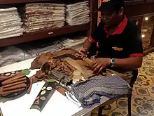 The "torcedor" is considered an artisan. Press and cut the wrapper with a guillotine, roll it up and finish the cigar.