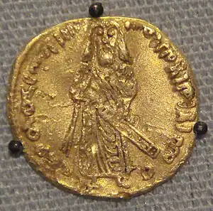 Coin with protruded inscription in Arabic and a bearded man standing with sheathed sword, seen face-on