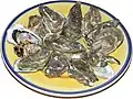 Ostras crudas, alimento típico de la gastronomía francesa divulgado globalmente.