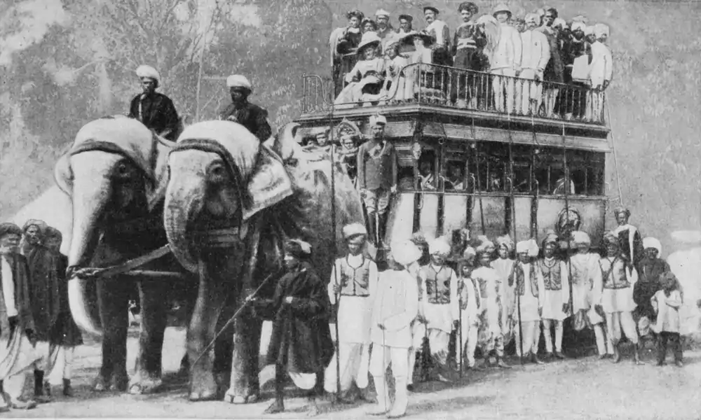 image of weeding guests in a omnibus-like vehilcle with elephants in front
