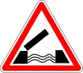 A triangle with white background and red border, with a symbol of an open draw bridge