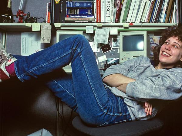 Susan Kare at a desk with feet elevated.