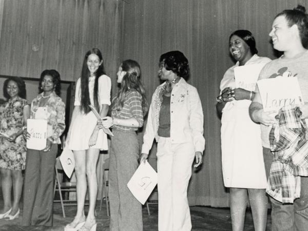 group of women standing on stage