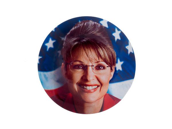 Circular photo of Sarah Palin’s headshot against the background of an American flag. 