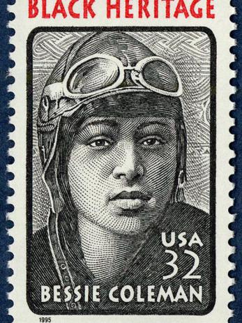 alt="Stamp featuring an Etching of Bessie Coleman wearing her flying helmet and goggles "